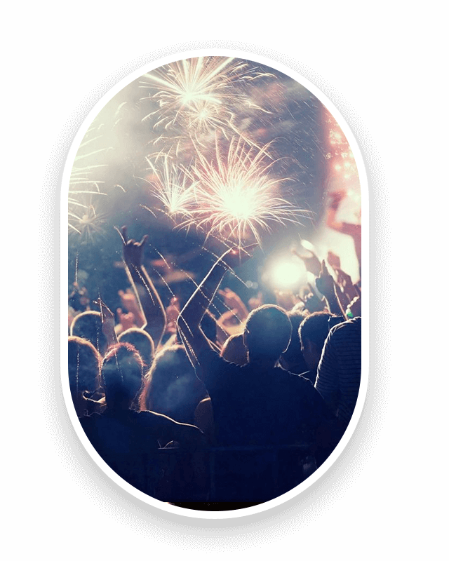 A group of people watching fireworks in the air.